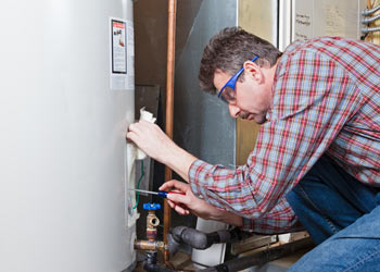 man repairing water heater